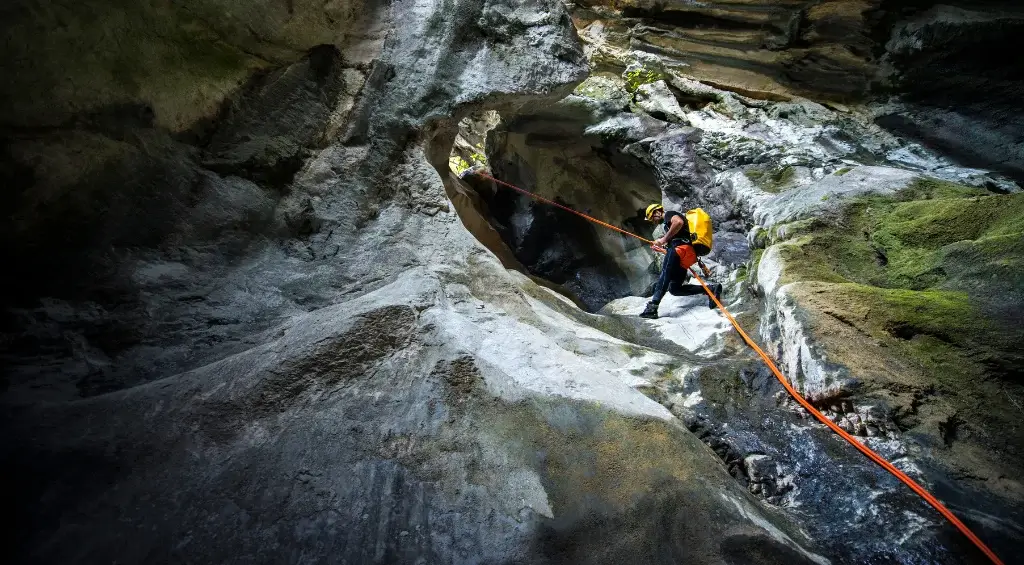 pessoas descendo de rapel na caverna