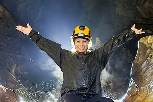 visitante de braços abertos dentro da caverna do diabo
